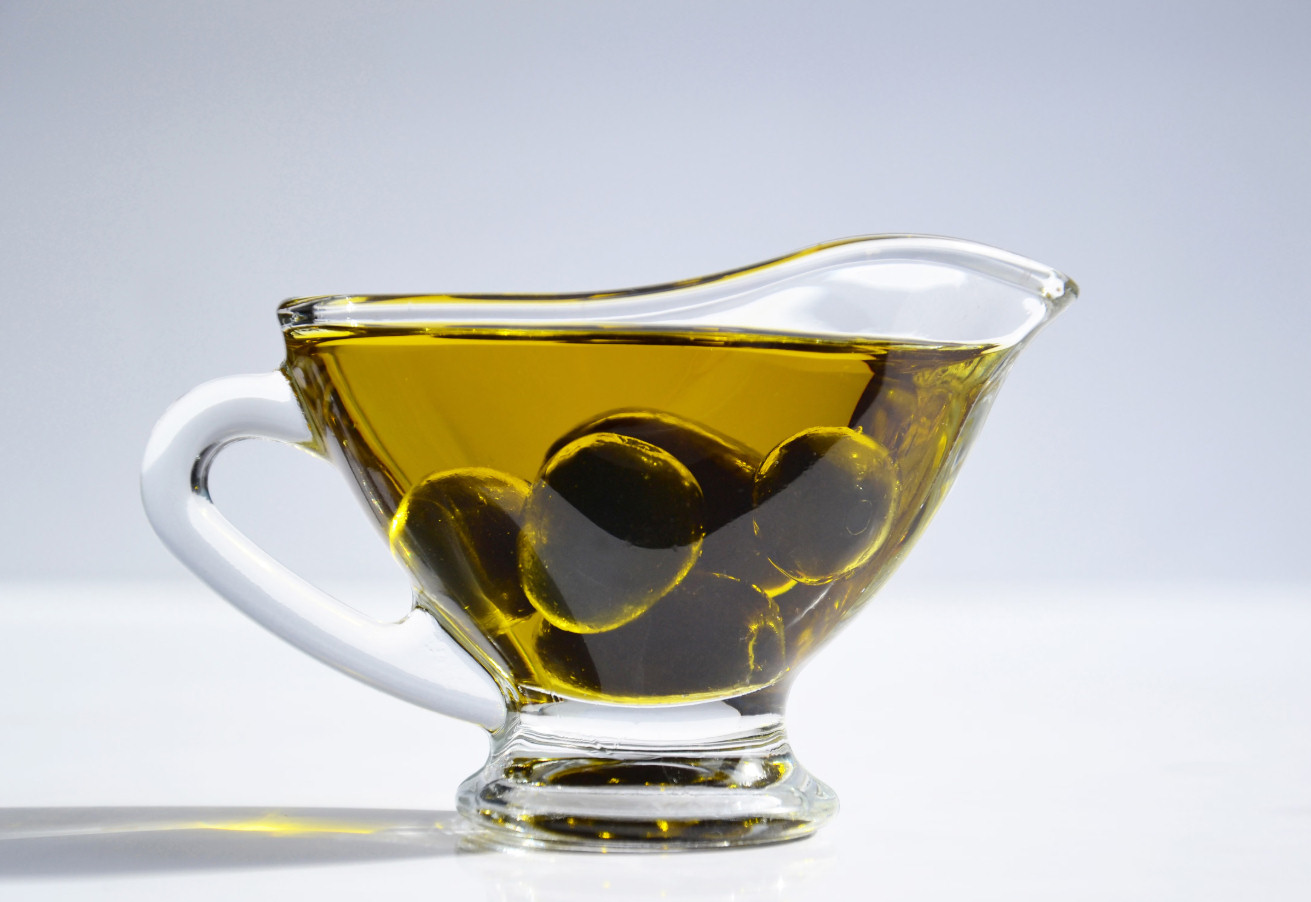 Olives and a cup of olive oil